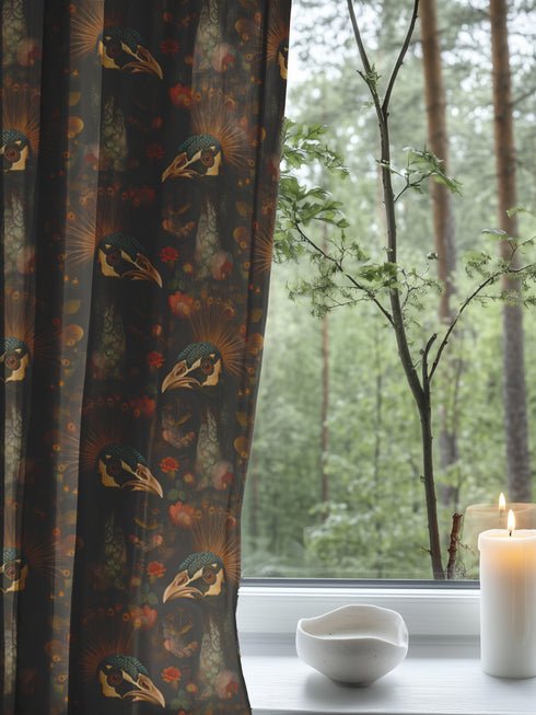 A sheer curtain panel featuring a repeating pattern of amber and forest green peacocks with botanical fan motifs on a dark background, creating a sophisticated Victorian gothic design.